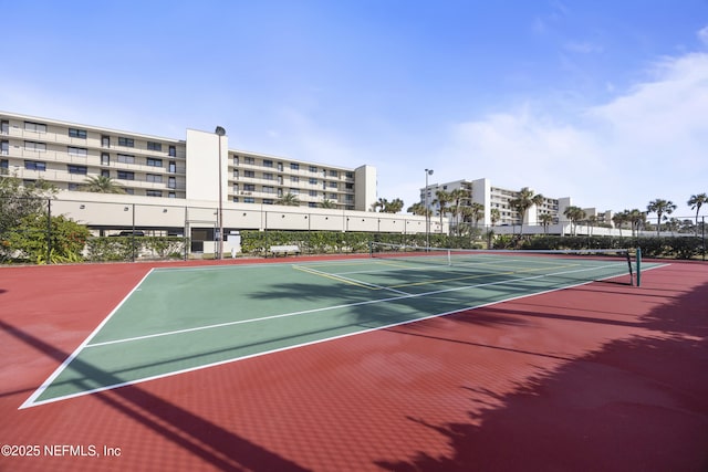 view of tennis court featuring basketball hoop