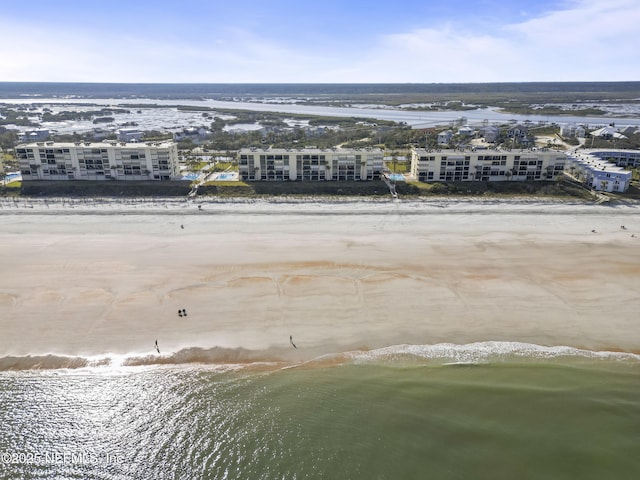 drone / aerial view with a water view and a view of the beach