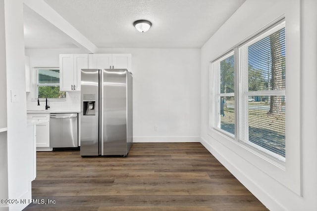 kitchen with white cabinetry, sink, dark hardwood / wood-style floors, and appliances with stainless steel finishes