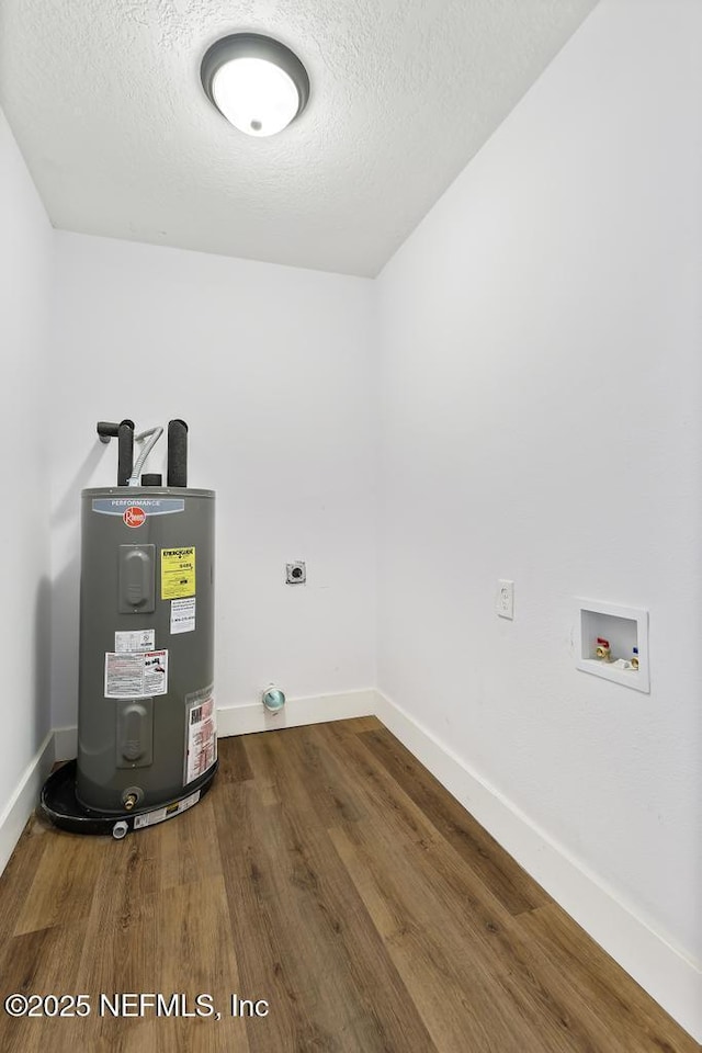 clothes washing area with water heater, wood-type flooring, hookup for a washing machine, electric dryer hookup, and a textured ceiling