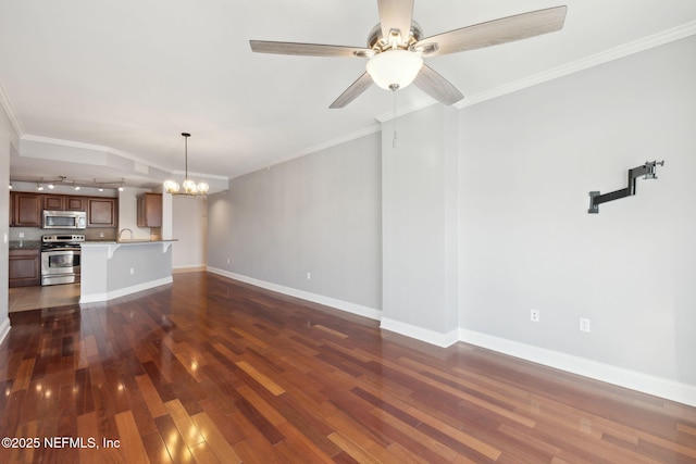 unfurnished living room with dark hardwood / wood-style flooring, ceiling fan with notable chandelier, and ornamental molding