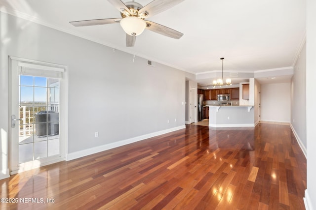 unfurnished living room with dark wood-type flooring, crown molding, and ceiling fan with notable chandelier