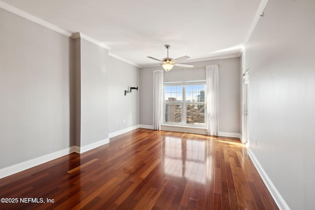 empty room with ornamental molding, dark hardwood / wood-style floors, and ceiling fan