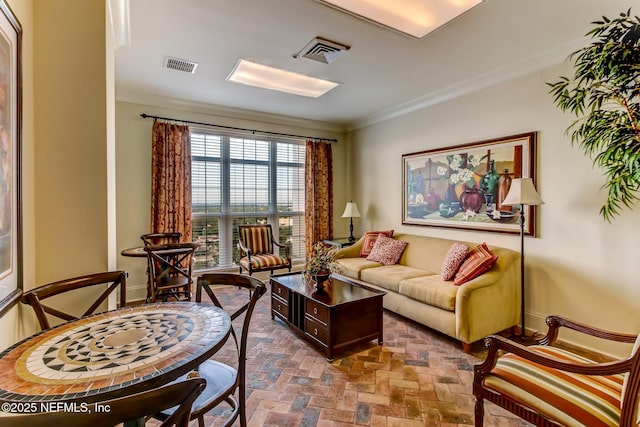 living area featuring crown molding