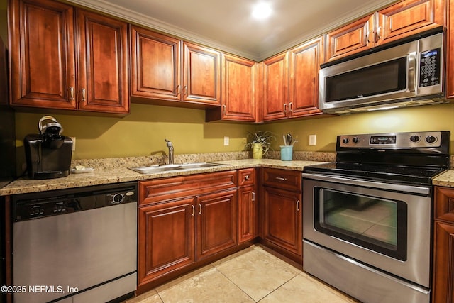 kitchen featuring light stone counters, appliances with stainless steel finishes, sink, and light tile patterned floors