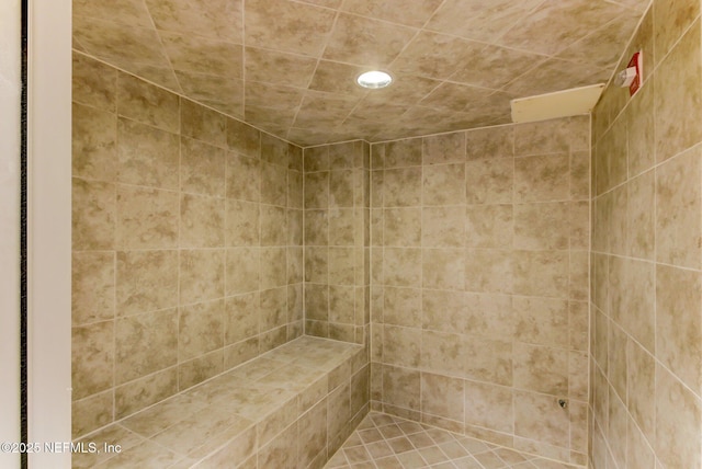 bathroom with tiled shower