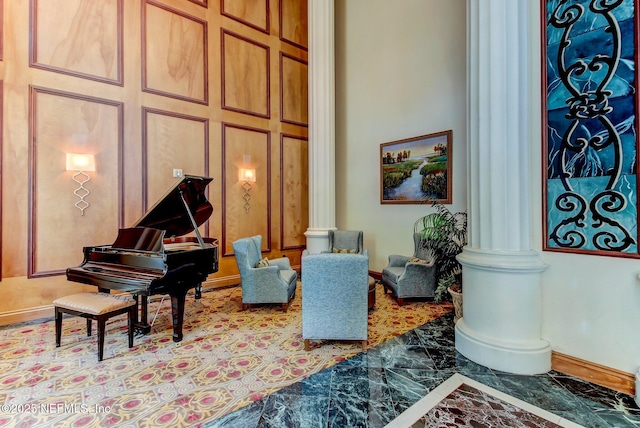 sitting room featuring ornate columns