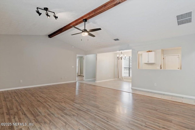 unfurnished living room with vaulted ceiling with beams, ceiling fan with notable chandelier, a textured ceiling, and light wood-type flooring