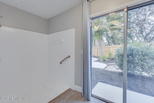 bathroom with hardwood / wood-style floors and a textured ceiling