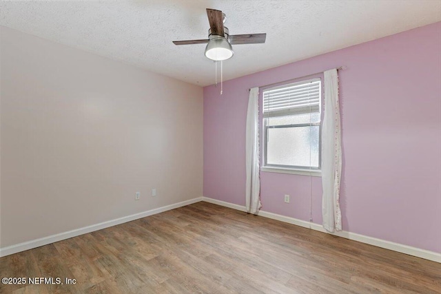 empty room with ceiling fan, a textured ceiling, and light hardwood / wood-style floors