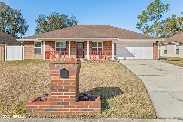 ranch-style house with a garage, a front lawn, and a porch