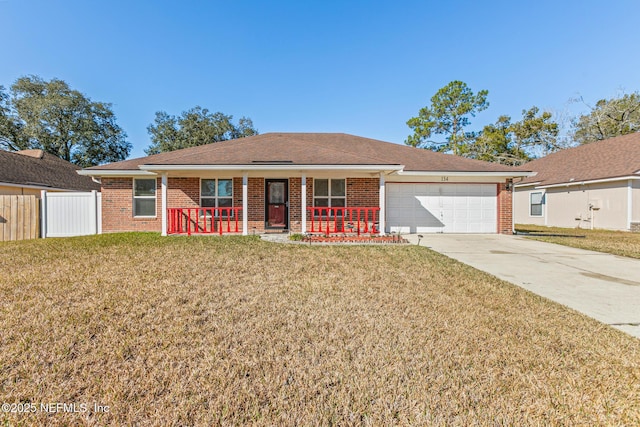 single story home with a garage, a front lawn, and covered porch