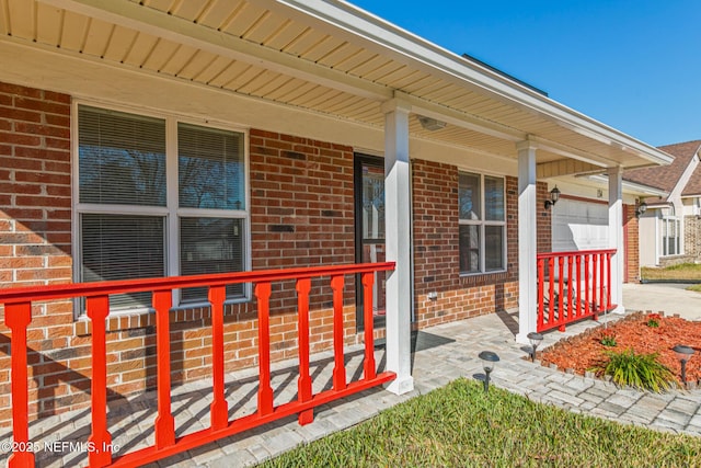 property entrance with a garage and covered porch