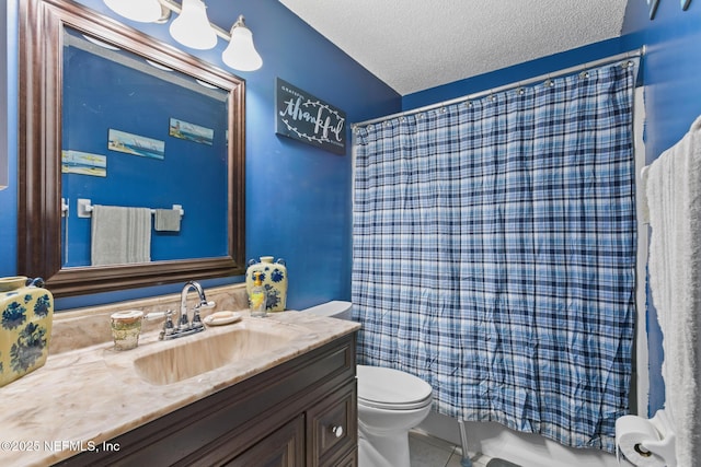 bathroom with vanity, tile patterned flooring, toilet, and a textured ceiling