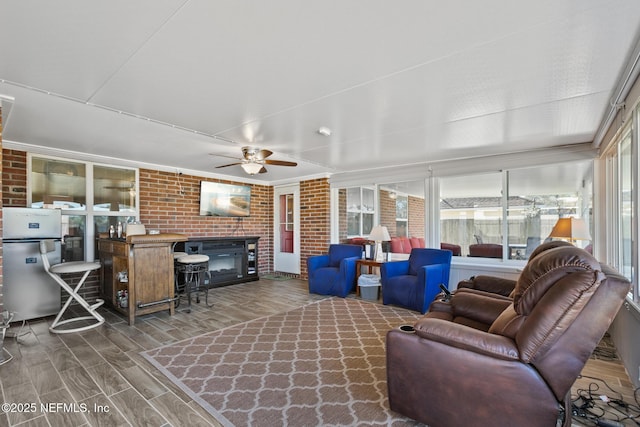 sunroom featuring ceiling fan