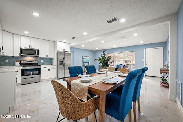 dining space featuring a textured ceiling