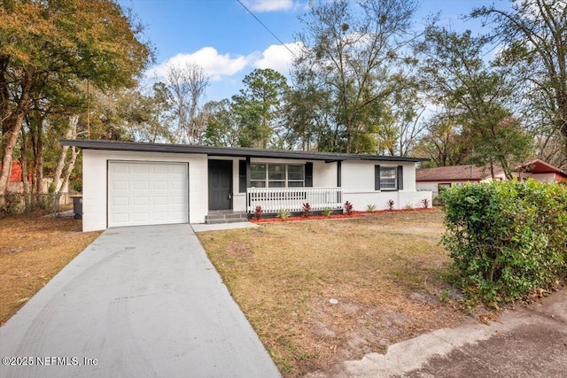 single story home with a garage, covered porch, and a front lawn