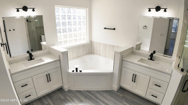 bathroom with vanity, hardwood / wood-style flooring, and separate shower and tub