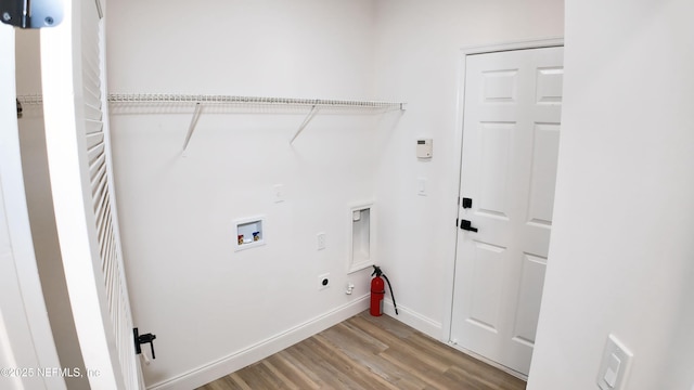 laundry area with washer hookup, hookup for an electric dryer, and light wood-type flooring