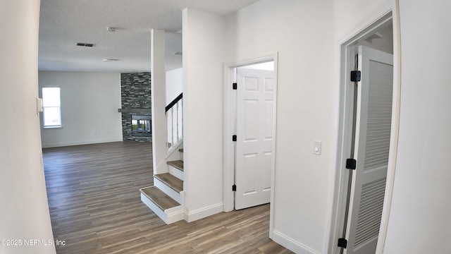 interior space featuring wood-type flooring and a textured ceiling