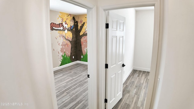 corridor with light hardwood / wood-style flooring