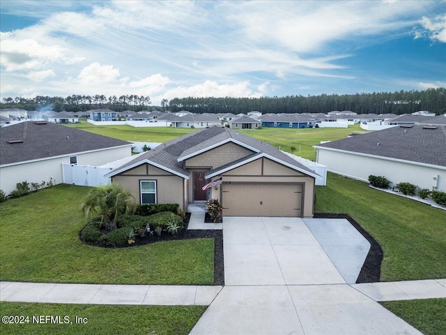 single story home with a garage and a front lawn