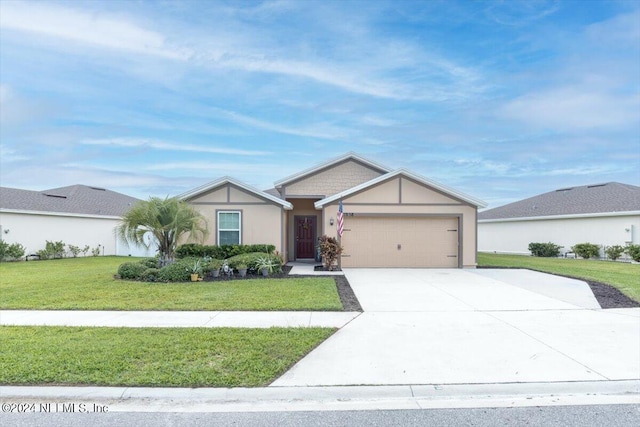 single story home with a garage and a front lawn