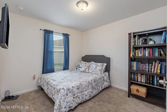 carpeted bedroom with a textured ceiling