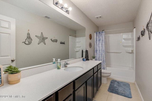 bathroom featuring vanity, tile patterned flooring, toilet, and a textured ceiling