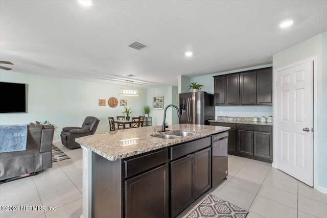 kitchen with sink, dark brown cabinets, black dishwasher, an island with sink, and stainless steel fridge with ice dispenser