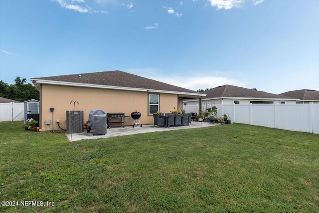 back of property featuring a patio, cooling unit, a shed, and a lawn