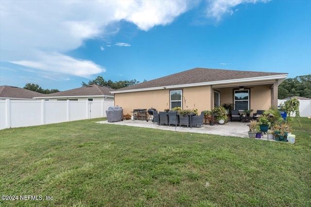 back of property with a patio area and a lawn