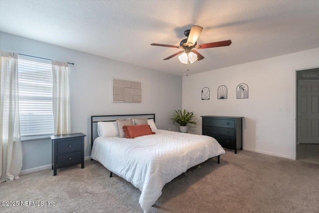 carpeted bedroom with ceiling fan and a textured ceiling