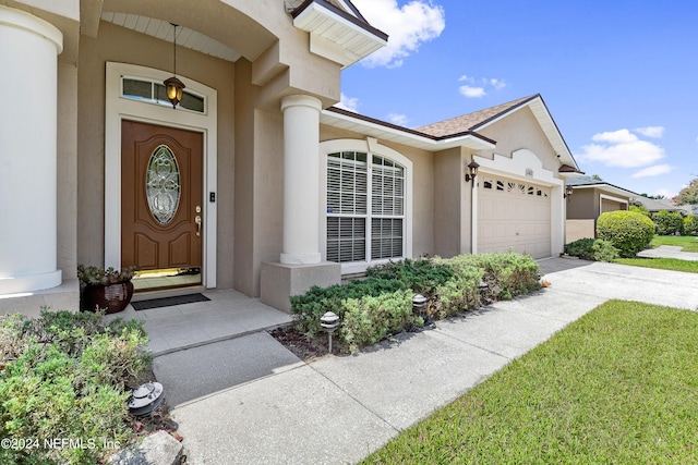 view of exterior entry with a garage