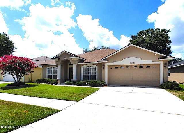 ranch-style home with a garage and a front yard