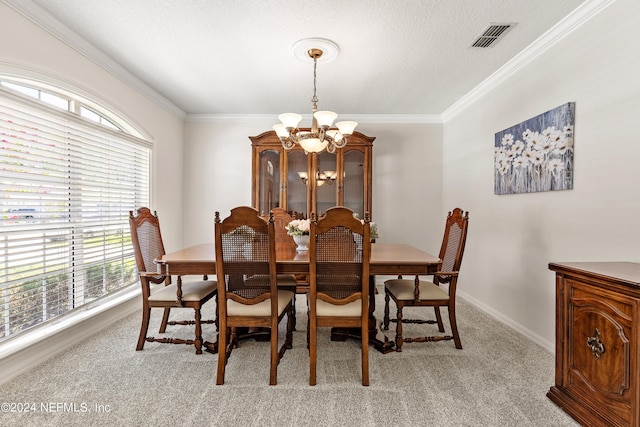 carpeted dining room featuring a notable chandelier, ornamental molding, and a textured ceiling