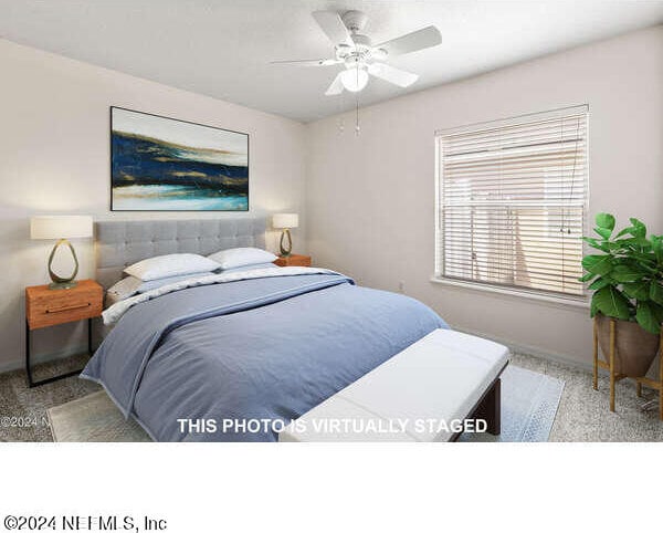 carpeted bedroom featuring ceiling fan