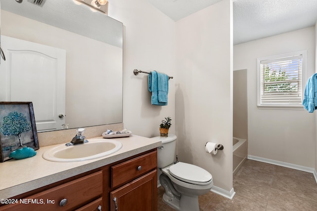 bathroom with vanity, tile patterned floors, and toilet