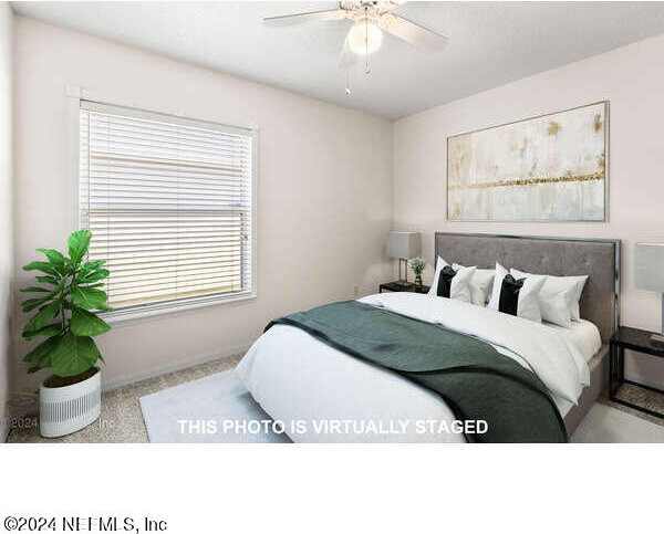 bedroom with ceiling fan and multiple windows