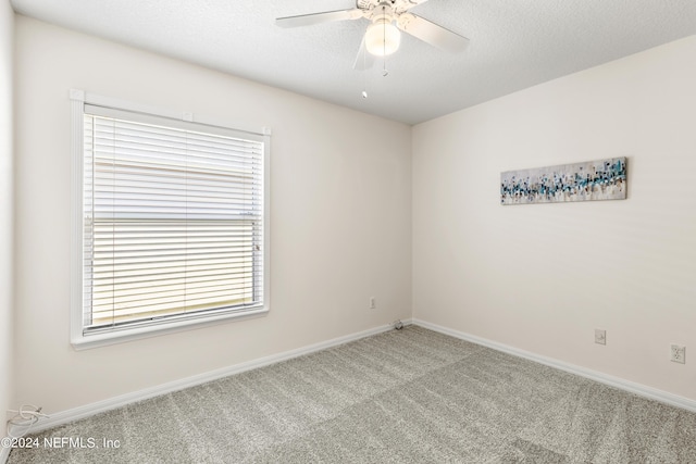 unfurnished room featuring ceiling fan, carpet, and a textured ceiling