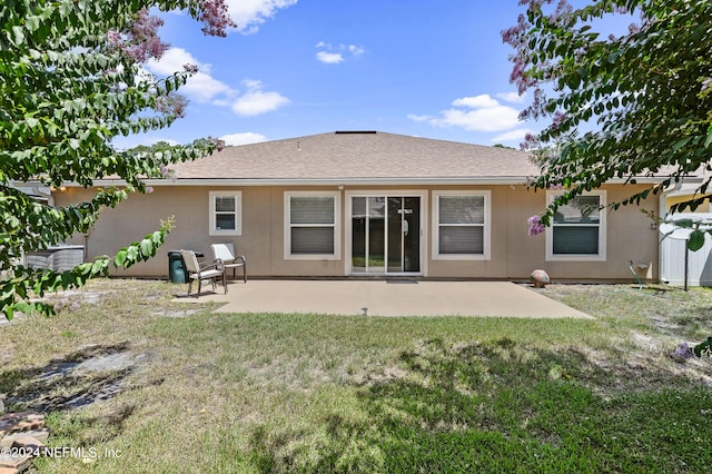 back of house with a yard and a patio area