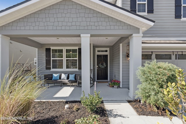 entrance to property with a garage and covered porch