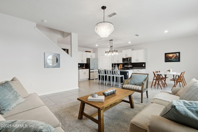 tiled living room with a chandelier