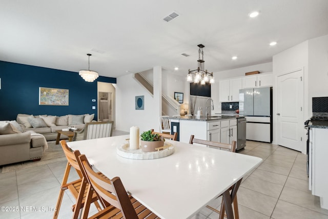 dining space with sink and light tile patterned floors