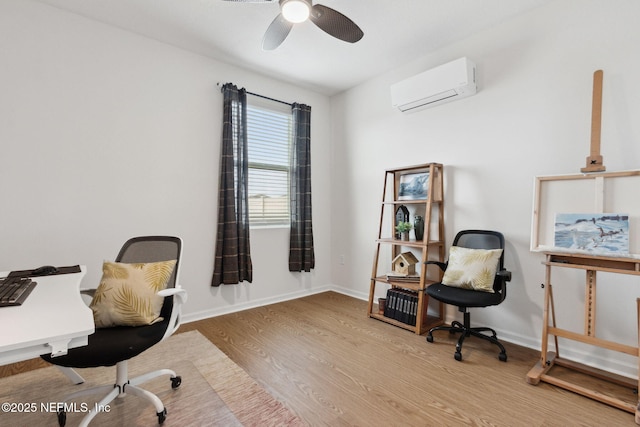 office area featuring hardwood / wood-style flooring, an AC wall unit, and ceiling fan