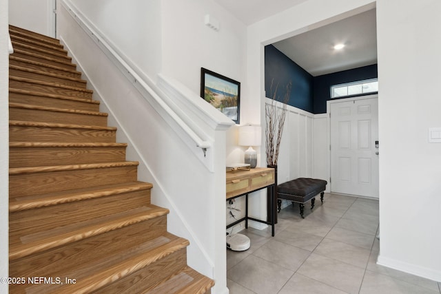 stairway with tile patterned floors