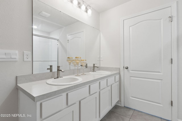 bathroom featuring tile patterned flooring, vanity, and an enclosed shower