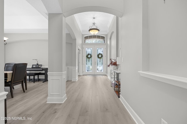 entryway featuring light hardwood / wood-style flooring and french doors