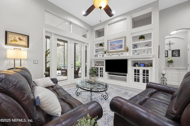 living room with french doors, hardwood / wood-style floors, ceiling fan, and built in shelves