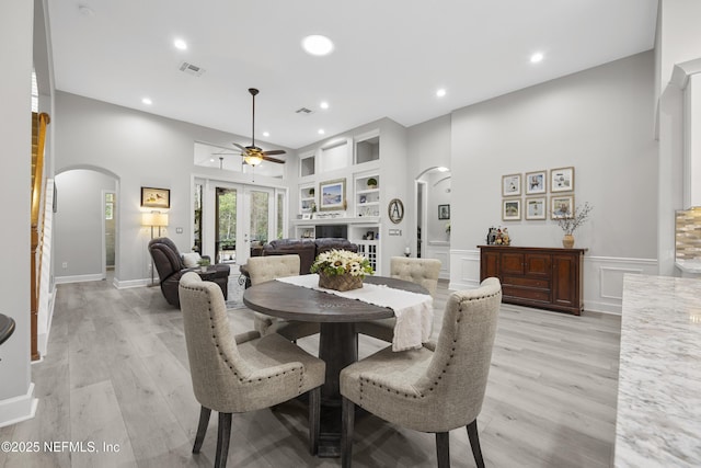 dining area featuring built in features, french doors, and light wood-type flooring